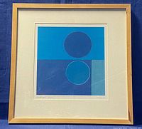 Framed lithograph showing the abstract art with geometrical shape composition in primarily blue tones.