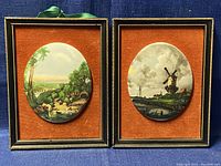 Pair of framed bone china miniature oval wall hanging art pieces on an orange background mat, both shown front view with ribbons for hanging.