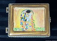 Top view of copper trinket box showing enamel painting inspired by Klimt with couple embracing and geometric pattern, signed Klimt.