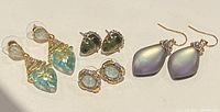 Four pairs of vintage Alexis Bitter signed costume earrings displayed on white background, showing front side with diverse colors and styles