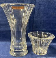 Front view showing Nachtmann vase on left and Orrefors bowl on right, displaying clear crystal with vertical ribbed patterns and segmented ridges respectively.