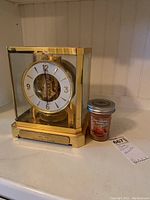 Clock and candle displayed side by side on mantel