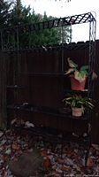 Frontal view of full shelf unit outdoors with leaf debris on lowest tiers
