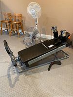Full view of Pilates Power Gym machine on textured mat