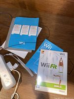 Close-up of Wii Fit game disc case and related manuals.