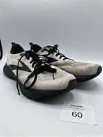 Pair of Brooks Revel 5 running shoes shown from a front angled side view on white background.