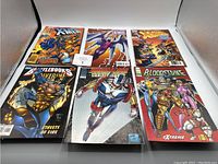 Photo showing all six comics arranged in two rows of three, displays cover art clearly including X-Men, Youngblood, Wolverine, and Bloodstrike titles.
