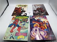 Lot of 4 comics including two Spawn issues, Amazing Spider-Man, and Homelands.