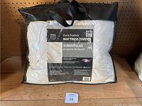Photo of the mattress topper in packaging with visible label and carrying case.
