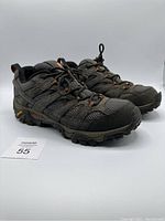 Side view of the pair of dark gray Merrell hiking shoes showing mesh and suede upper with Vibram sole.