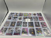 Full layout photo of 27 NFL rookie cards arranged in three rows, each card individually sleeved in clear plastic.