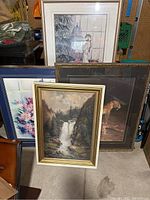 Four framed pictures including waterfall scene, leopard on a branch, floral image, and girl with birdcage near window.