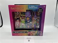 Full view of the sealed Rainbow High Secret Diary Set box showing all contents inside including the diary with illustrated characters, pen, locks, keys, and stickers.