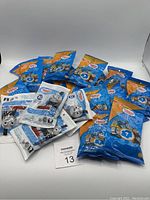Lot of multiple Thomas & Friends Minis blind bags with colorful packaging.