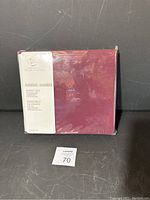 Twin sheet set packaging showing the deep burgundy color and the Home brand Essentials sheet set label.