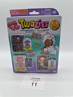 Twozies Season 2 collectible toy figure pack showing six toy figures and a surprise pet inside clear plastic blister on colorful cardboard backing