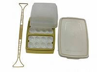 Yellow deviled egg holder, insert, lid, and yellow utensil shown from above on white background