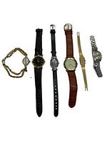 Photo showing six wristwatches arranged side by side with varied straps and dial colors.