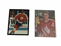 Two photos of Eric Lindros in Team Canada hockey uniforms; one in action and one portrait with autograph.