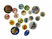 Photo showing 17 vintage McDonald's promotional buttons with various designs and slogans.