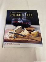 Front cover of the book 'Cheese Course' by Fiona Beckett showing cheese and wine glasses photo.