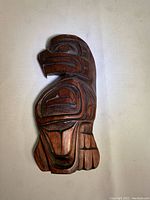 Front view of the eagle carving showing detailed traditional Indigenous carving style with bold lines and shapes.
