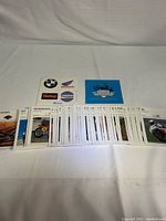 Wide view of 144 motorcycle cards spread out, showing various motorcycles and some with text and branding underneath.