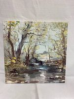 Front view of the original canvas painting showing the creek, trees, and natural outdoor scene.