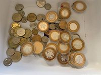 Assortment of loose and cased tokens in tray