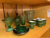Wide view of all green glassware and ceramic custard cups showing item grouping and condition