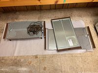 Three Mid-Century Modern electric warming trays laid out on a floor with power cords visible.