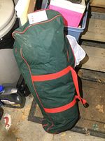Closed green and red fabric storage bag for storing wrapping materials