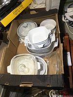 Photo showing the full box with stacked baking dishes and lids inside the box.