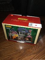 Original box of the Lemax Village Collection Lawsons Winery lighted building, showing the colorful front with product image and branding.