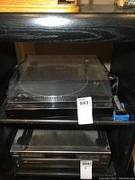 Front view of Realistic LAB-450 turntable including dust cover and brushes.