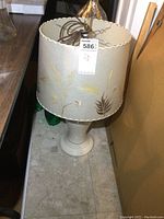 Full view of the lamp and lampshade showing the embroidered leaf design and overall height