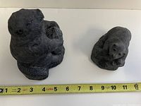 Both Inuit bear sculptures side by side with tape measure showing size