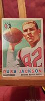 Front view of the 1959 Topps Russ Jackson rookie card, showing the player in action pose in colored printing with player name, position, and team.