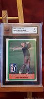 Front view of 1981 Donruss Jack Nicklaus golf card showing statistical leader notation and graded 7 NM by KSA in protective hard plastic case.