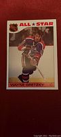 Front image of 1985 Wayne Gretzky NHL All-Star trading card with player action photo in Edmonton Oilers uniform.
