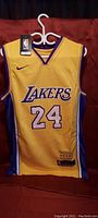 Front view of yellow Nike Lakers jersey with number 24 and Lakers logo.