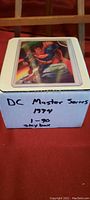 Photo of the box containing the complete set of DC Master Series trading cards from 1994, numbered 1 to 90 by SkyBox, with a card featuring Superman on top.
