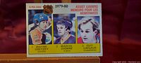 Front of 1980 O-Pee-Chee NHL Assist Leaders hockey card showing Wayne Gretzky, Marcel Dionne, and Guy Lafleur
