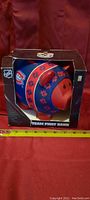Front view of the Montreal Canadiens piggy bank in its original box showing logo and packaging details.