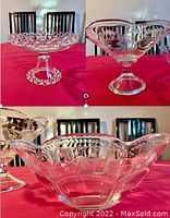 Set of 4 clear glass dessert platter and fancy bowls on pedestals arranged on red cloth. One large platter and three smaller matching bowls. View shows detailed scalloped edges and glass patterns.
