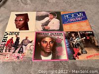Top view of six vinyl record covers showing Grace Jones, Michael Jackson, Motown, Bell Biv DeVoe, Michael Jackson Greatest Hits, Rick James.