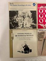 Top view of Bach - The Passion According to St. John and Giovanni Paisiello - The Barber of Seville vinyl album covers and records.