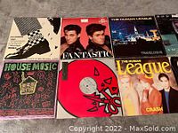 Photo showing six vinyl records including The Specials, Wham! Fantastic, The Human League Travelogue and Crash, House Music compilation, and a red vinyl record.