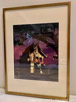 Framed photo showing the Wat Phra Singh Library building with ornamental Thai architecture in evening light.