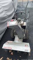 Front view of Craftsman snow blower showing chute, front housing with Craftsman label, and handles.